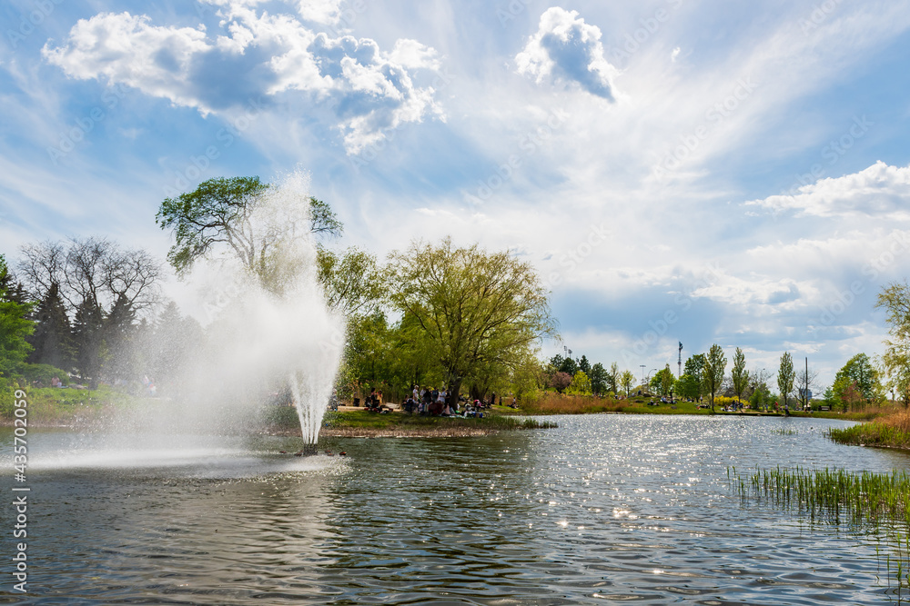 View of a Jarry park pond and fountain in Montreal, Canada