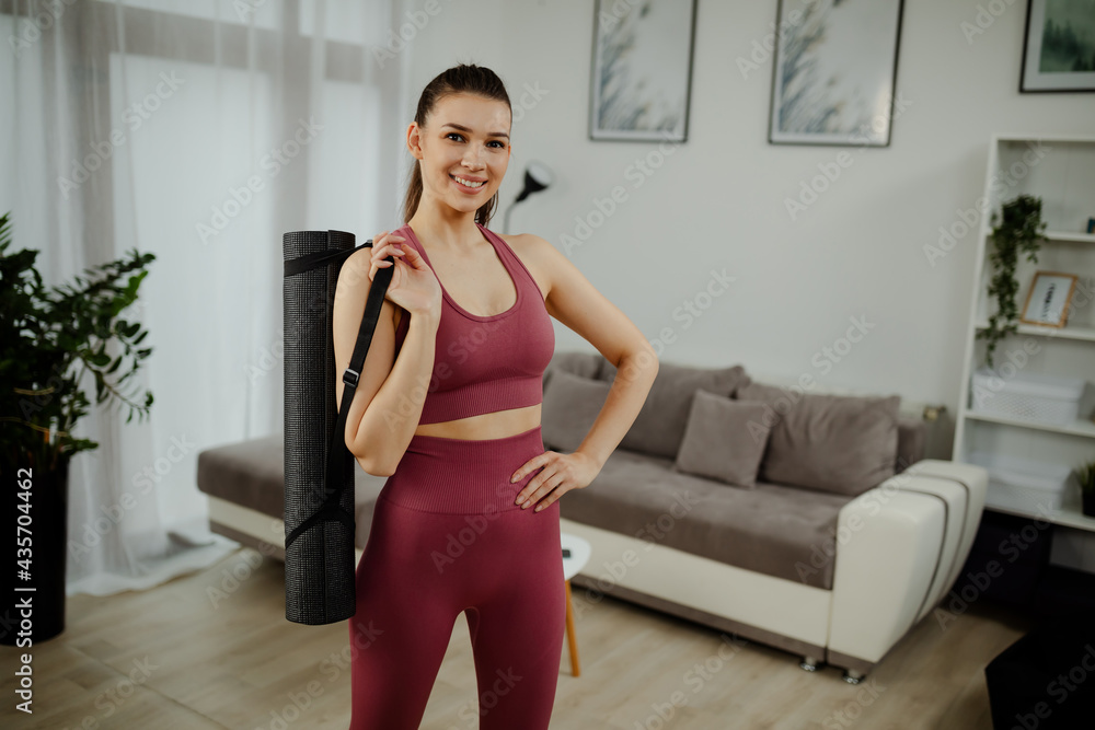 Portrait of excited yoga teacher posing with fitness mat looking at camera, happy fitness trainer. Portrait of excited yoga teacher posing with fitness mat looking at camera, happy fitness trainer.