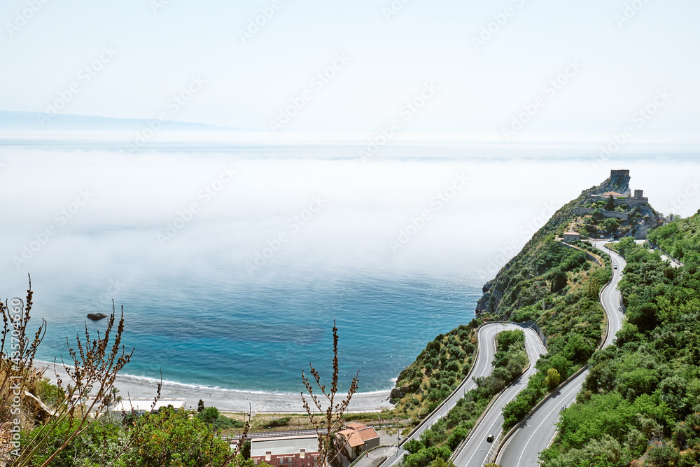 Sant'Alessio castle covered by fog. Beauty in Sicily as a tourist attraction. Season on mediterranean sea. Ionian sea.