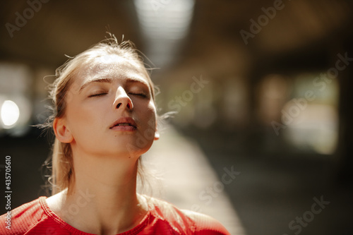 Close up photo of young beautiful fit woman enjoying in nature after running.