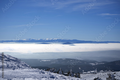 view of snowy mountains in fog