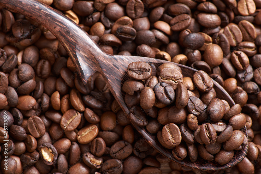 Coffee beans and grinder on table with rustic background Coffee beans and grinder on table with rustic background