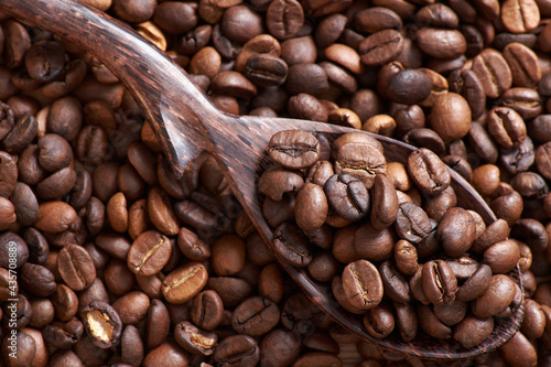 Coffee beans and grinder on table with rustic background