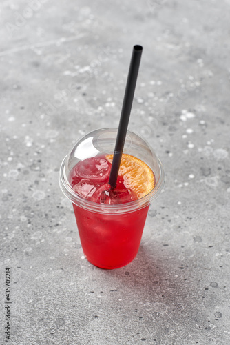 Colorful refreshment drink lemonade in plastic glasses, outdoor stand with takeaway food