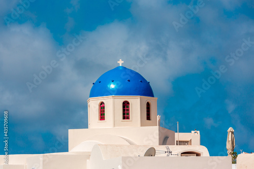 Greek white church with blue dome in Santorini.