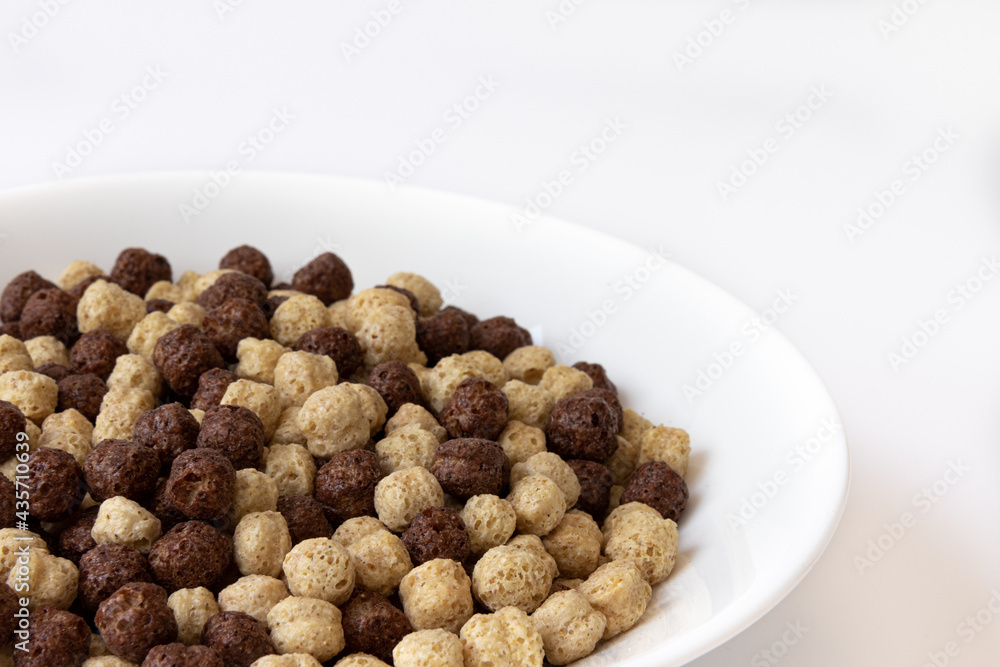 chocolate cereal in bowl isolated on white background chocolate cereal in bowl isolated on white background