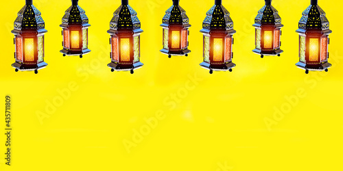 Ornamental Arabic lantern with burning candle glowing. Festive greeting card. Invitation for Muslim holy month or christmas, halloween holidays