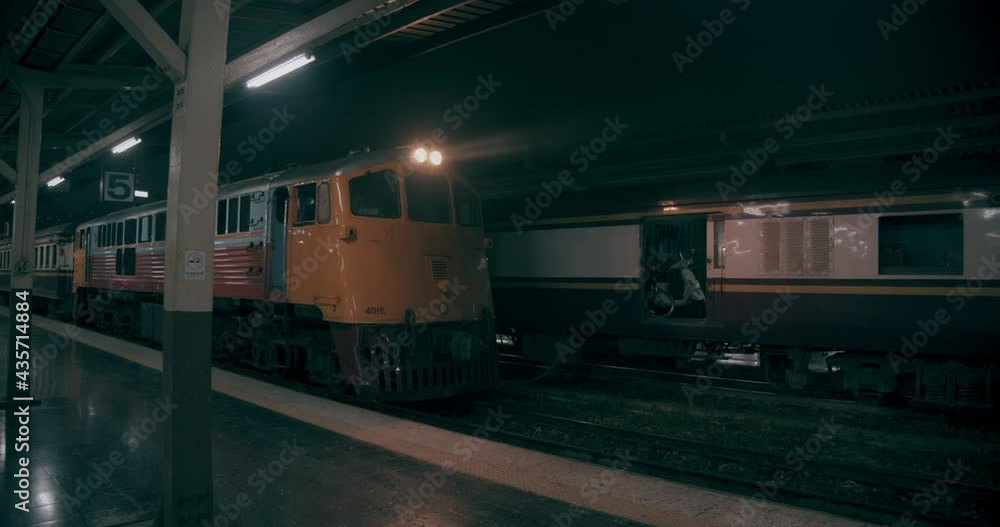 Empty Railway Station with a Yellow Train Parked
