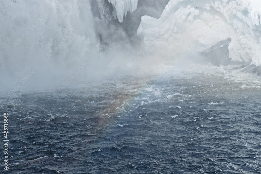 A winter rainbow at the Tännaforsen waterfall in northern Sweden A winter rainbow at the Tännaforsen waterfall in northern Sweden