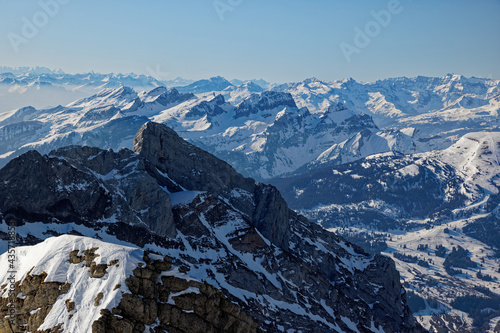 swiss mountain landscape in snow photographed from bird's eye view, cloudless sky, daytime, without people
