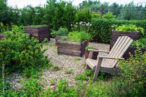 Photography Outdoor chair and vegetable garden in wooden boxes in prosperous village (Belgia