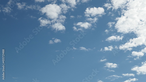 blue sky with truncated clouds seeming to vanish 