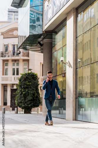 Successful young business man talking on cell phone