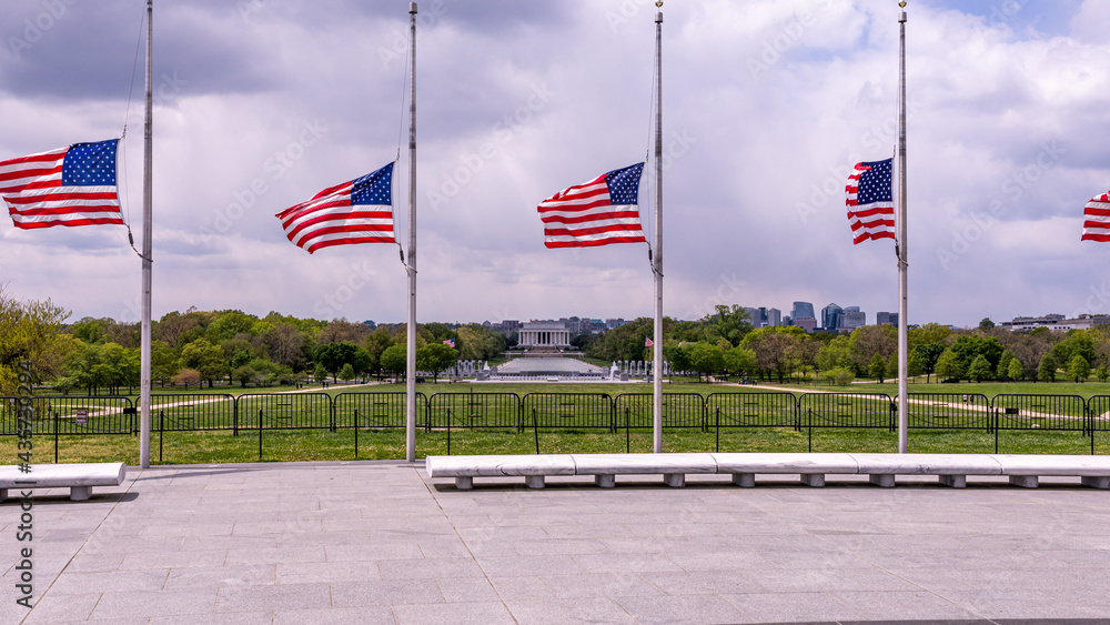 Panoramic view at Lincoln memorial behind the US flags from the ground of Washington monument.