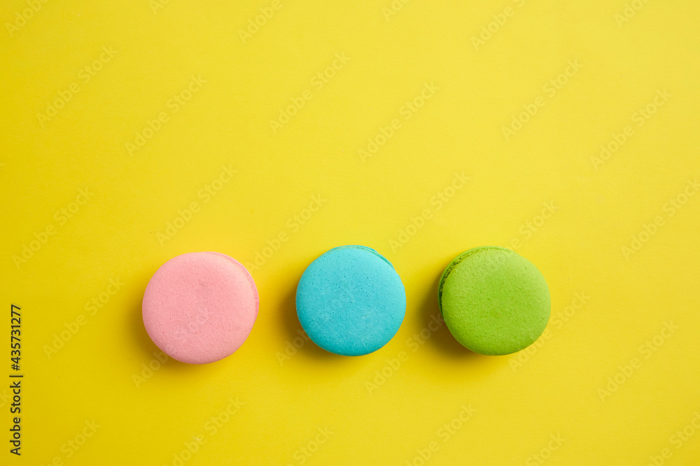French macaroon biscuits on colorful background French macaroon biscuits on colorful background