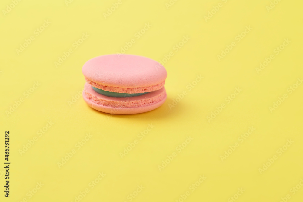Pink macaroons on bright yellow background Pink macaroons on bright yellow background