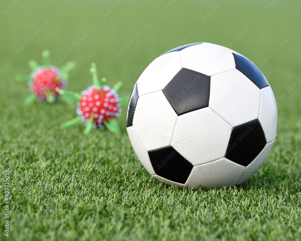 Fototapeta premium Soccer Ball with Corona Virus Risk Outside