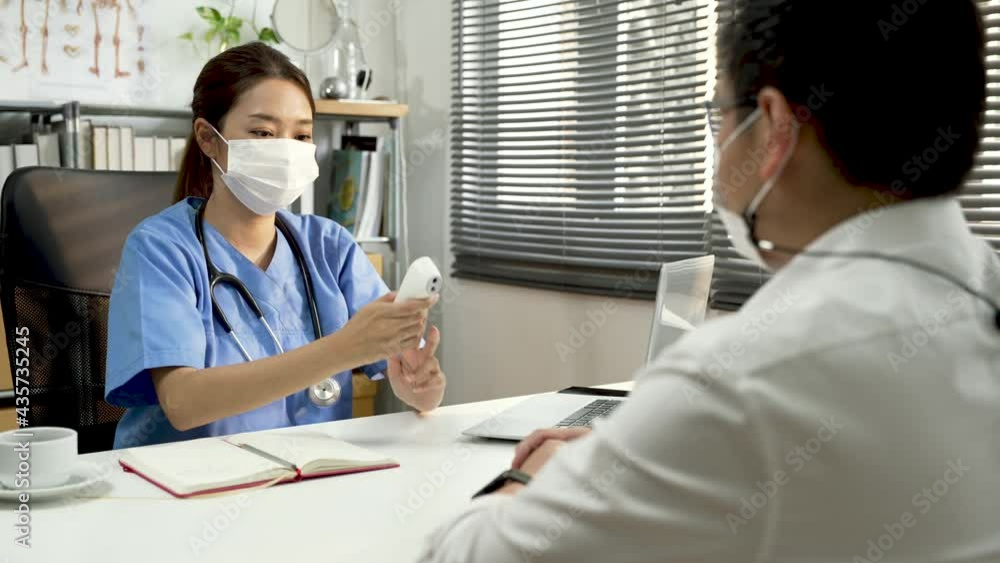 Doctor measuring temperature of patient by infrared meter. Doctor measuring temperature of patient by infrared meter.