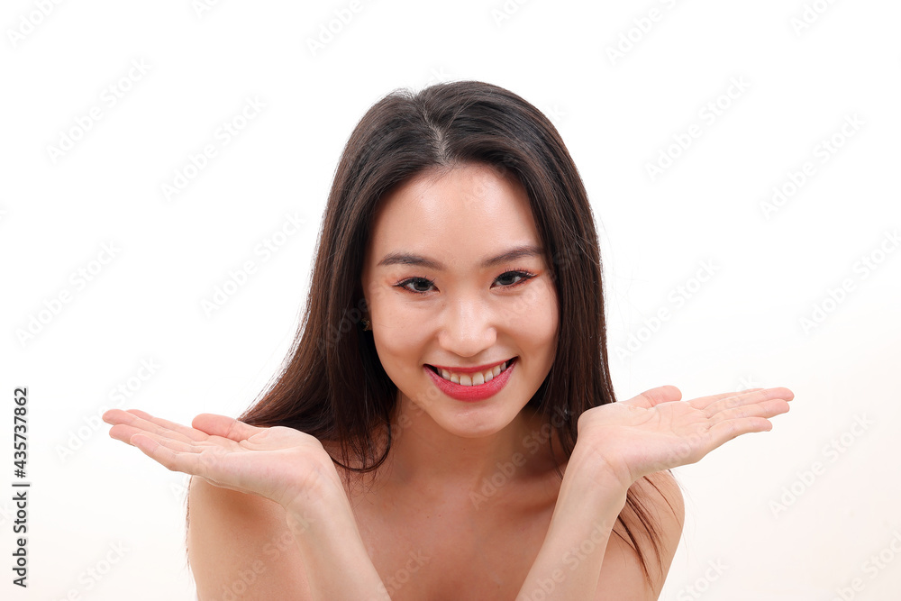 Beautiful young south east Asian woman posing holding hands palms up flat show display offer see white background Beautiful young south east Asian woman posing holding hands palms up flat show display offer see white background