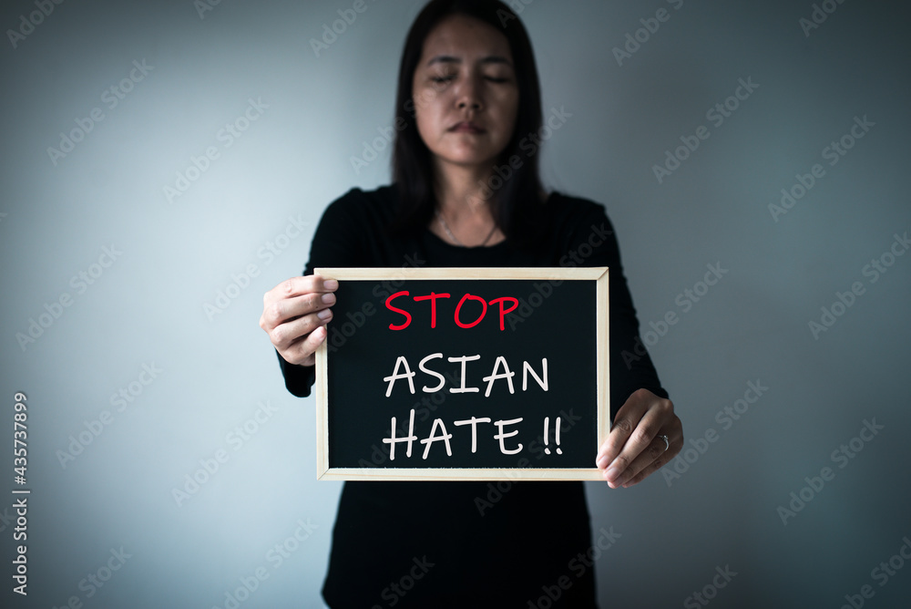 Woman showing text stop asian hate,Racism against asian people campaign,Stop asian hate concept Woman showing text stop asian hate,Racism against asian people campaign,Stop asian hate concept