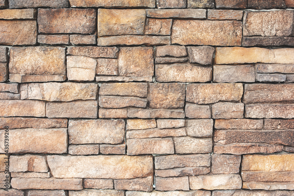 A view of a rustic stone wall as a background. A view of a rustic stone wall as a background.