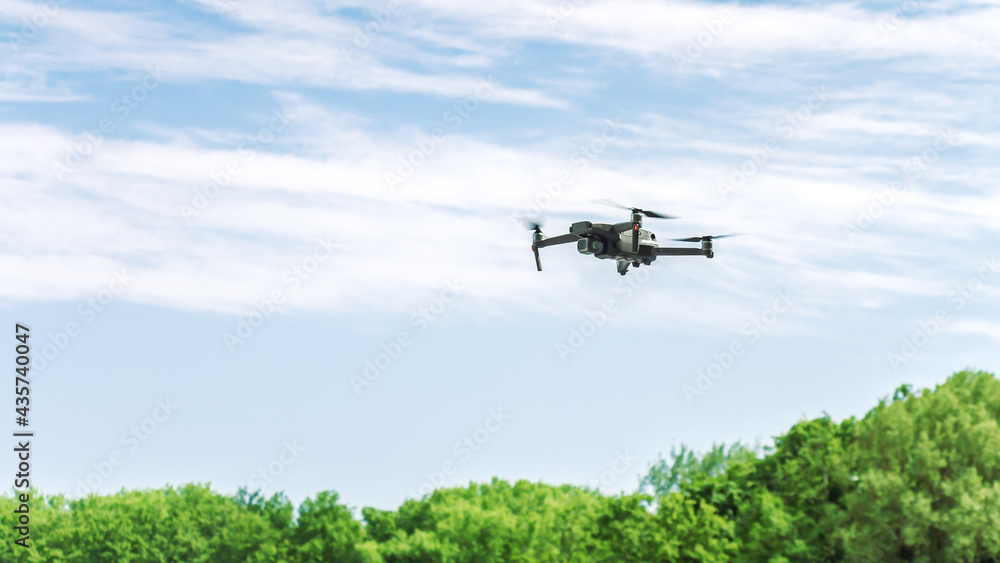 Fototapeta premium drone with high resolution photo camera flying over summer forest