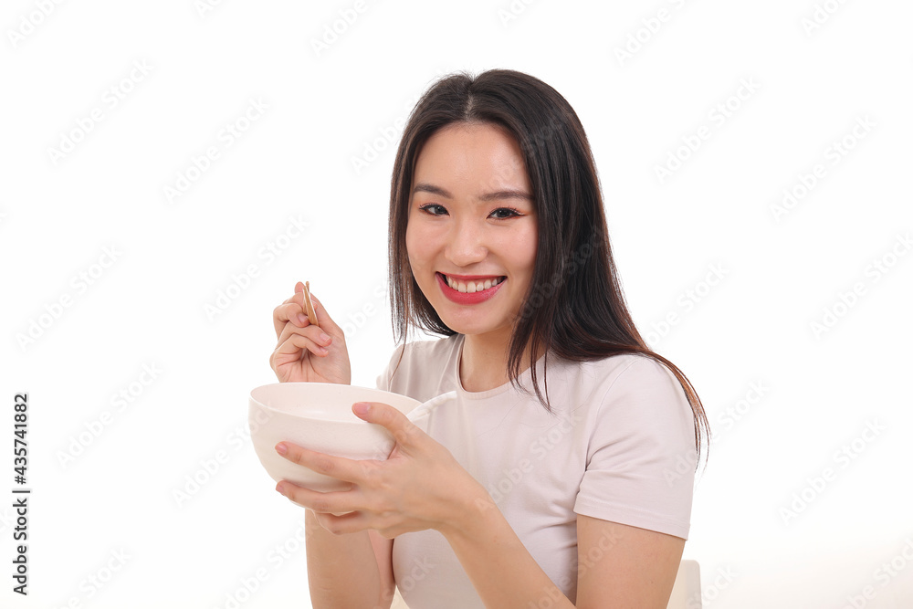 Beautiful young south east Asian woman holding chinese empty chopstick soup spoon bowl utensil pretend acting posing see eat taste feed offer satisfaction yummy white background happy Beautiful young south east Asian woman holding chinese empty chopstick soup spoon bowl utensil pretend acting posing see eat taste feed offer satisfaction yummy white background happy