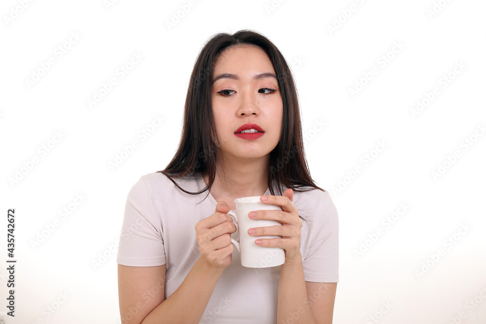 Beautiful young south east Asian woman holding white coffee tea cup emotion expression on white background look Beautiful young south east Asian woman holding white coffee tea cup emotion expression on white background look