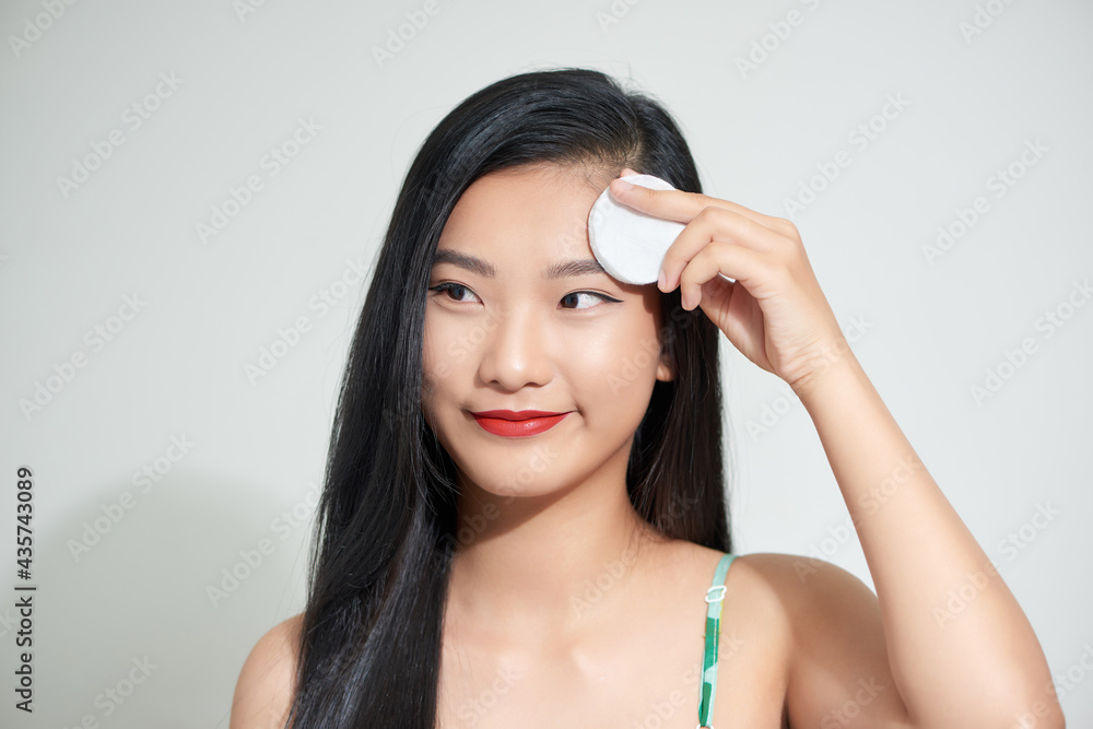 Young woman holding sponge in her hands isolated on white background Young woman holding sponge in her hands isolated on white background