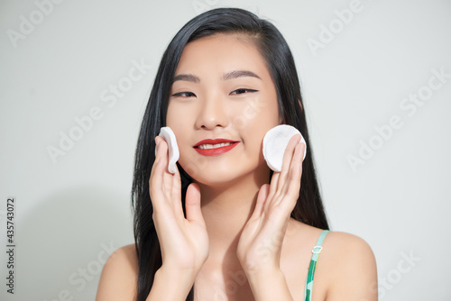 Happy Smiling Female Taking Off Makeup From Facial Skin With Cosmetic Pad