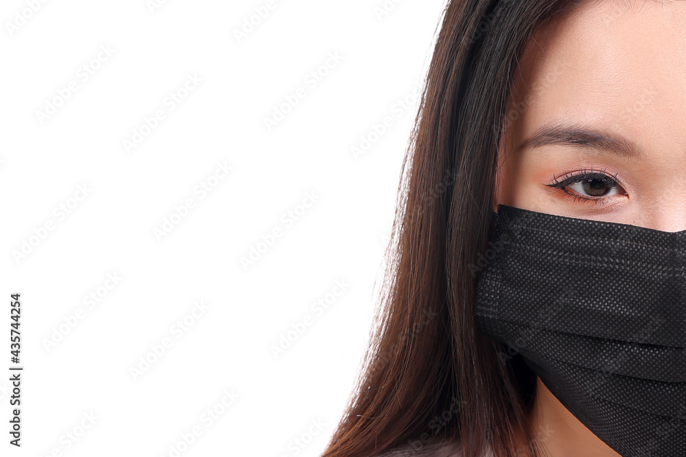 Beautiful young south east Asian woman wearing black three ply anti virus surgical face mask on white background Beautiful young south east Asian woman wearing black three ply anti virus surgical face mask on white background