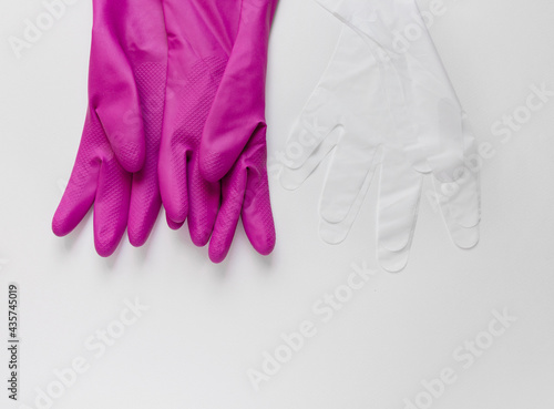 Two pair of different protective gloves lie on white table. Top view set. © Nadezhda