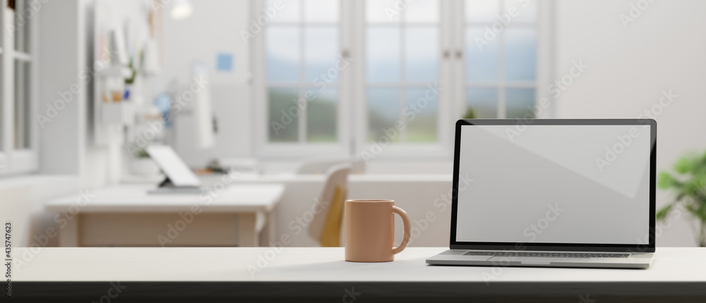 Laptop with mock-up screen and coffee mug on the table in comfortable office room, 3D rendering
