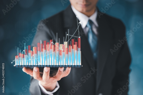 Businessman hand show Stock chart showing rising stock sign with graph indicator. Interest rate financial and mortgage rates concept. Double Exposure Image. Blue technology background high tech.