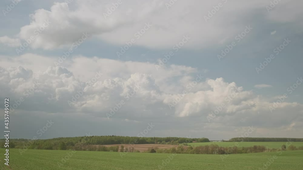 Timelapse clouds running across sky over fields. Timelapse clouds running across sky over fields.