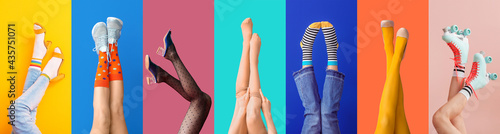 Legs of young woman in socks and sandals on color background photo