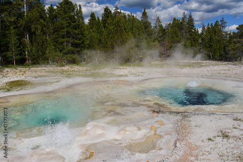 the two vents of the spasmodic geyser in the upper geyser basin of yellowstone national park in wyoming