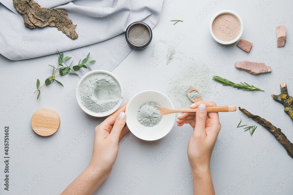 Woman preparing facial mask on grey background Woman preparing facial mask on grey background