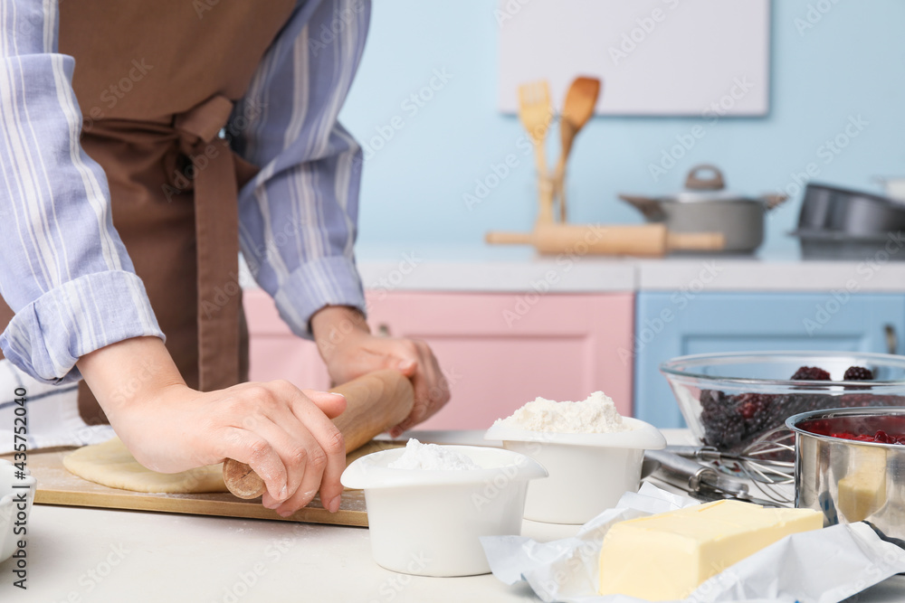 Woman making dough on board in kitchen Woman making dough on board in kitchen