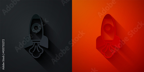 Paper cut Rocket ship icon isolated on black and red background. Space travel. Paper art style. Vector