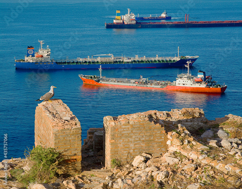 Commercial ships at anchor in Gibraltar Bay seen from old battlements. photo