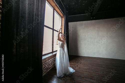 young and beautiful bride blonde in a dark interior
