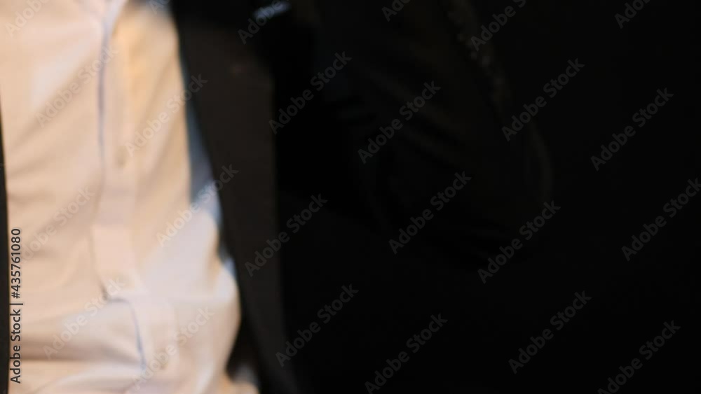 Man wearing a suit whiskey glass of liquor and a phone Man wearing a suit whiskey glass of liquor and a phone