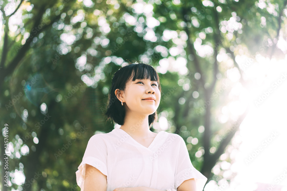Young adult business asian woman walking in public park outdoor. Young adult business asian woman walking in public park outdoor.