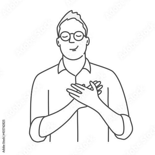 Positive man in glasses holds his hands on his chest, expressing gratitude.