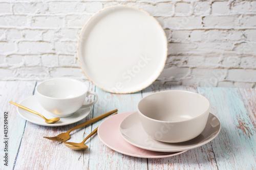 Set table with salt  empty serving utensils on a light table