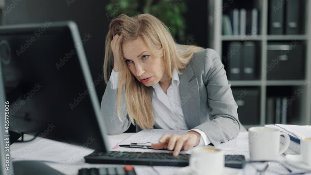 Overworked woman typing on computer Overworked woman typing on computer