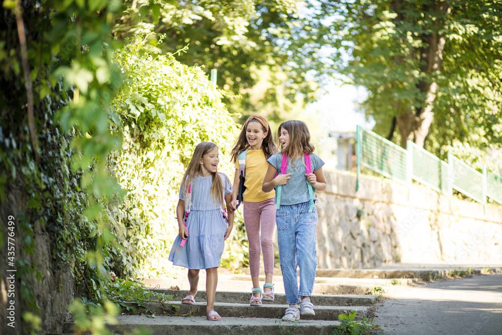Three little girls walking trough park. Three little girls walking trough park.