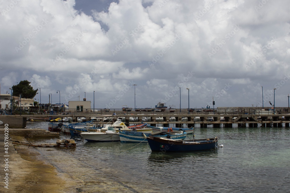 evocative image of fishing boats moored in the harbor in a small fishing village in Sicily, Italy
evocative image of fishing boats moored in the harbor in a small fishing village in Sicily, Italy