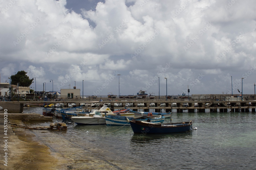 evocative image of fishing boats moored in the harbor in a small fishing village in Sicily, Italy
